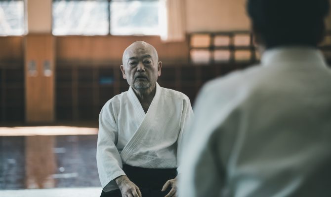 Aikido Master sitting in Dojo
