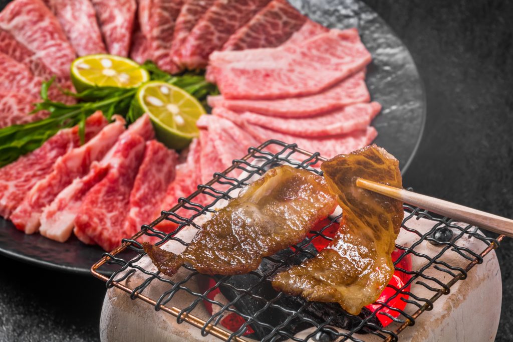 Two pieces of wagyu meat grilled on a grilling net